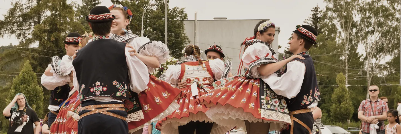 couple wearing traditional outfits dancing in open air